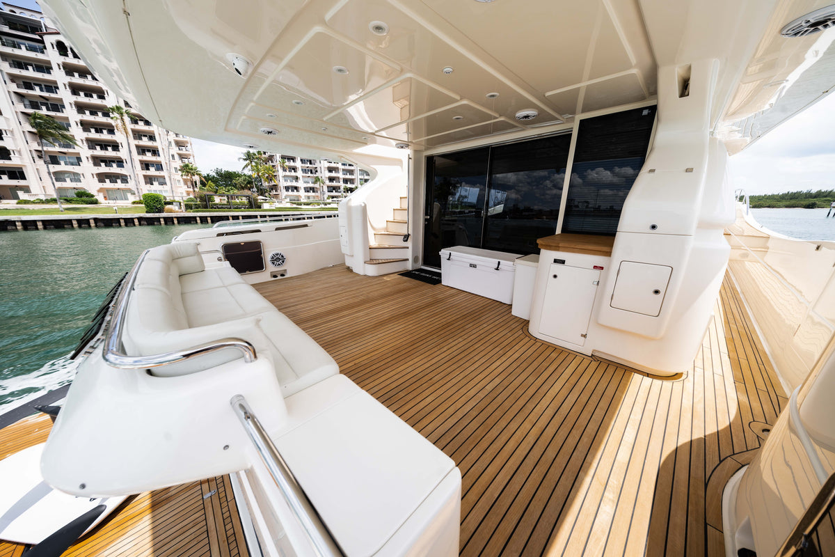 Shaded aft deck with white seating and teak flooring