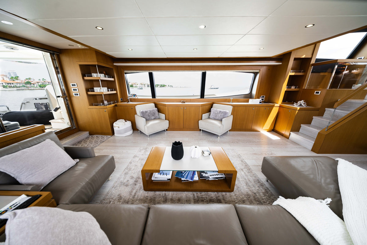 Bright wood-paneled salon with sofas, armchairs, and a central coffee table